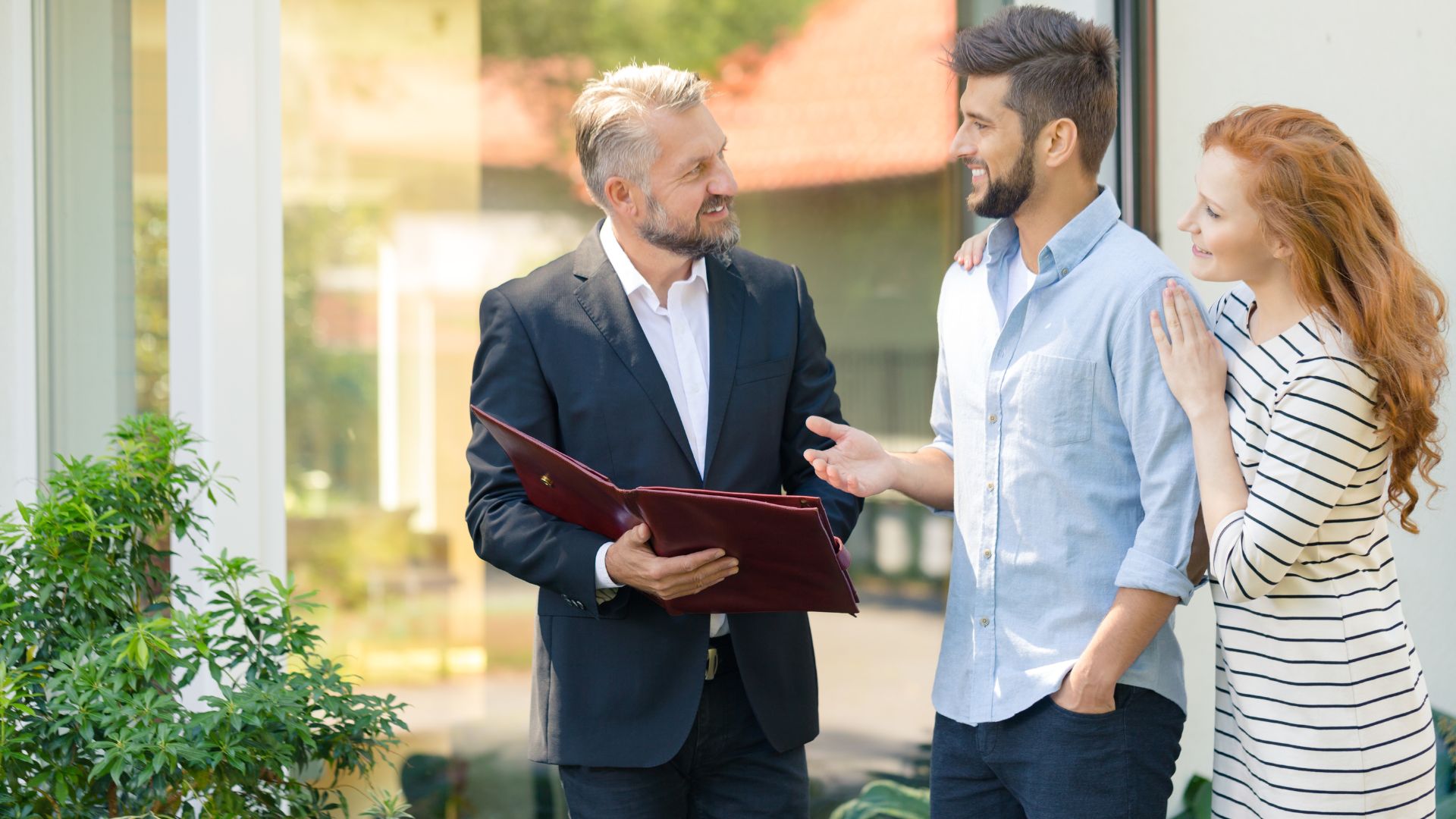 Realtor showing property while AI handles incoming buyer calls on phone